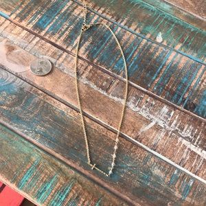Gold sideways cross necklace